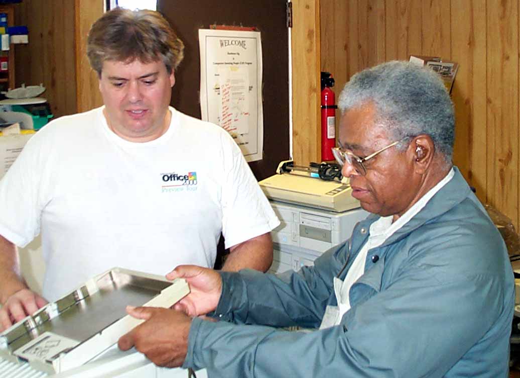 CAP volunteers Dan Hanson and Dan Davenport checking out a printer