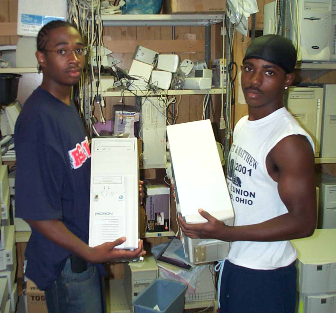 Anthony Dunn and Jermaine Hunter loading new computers