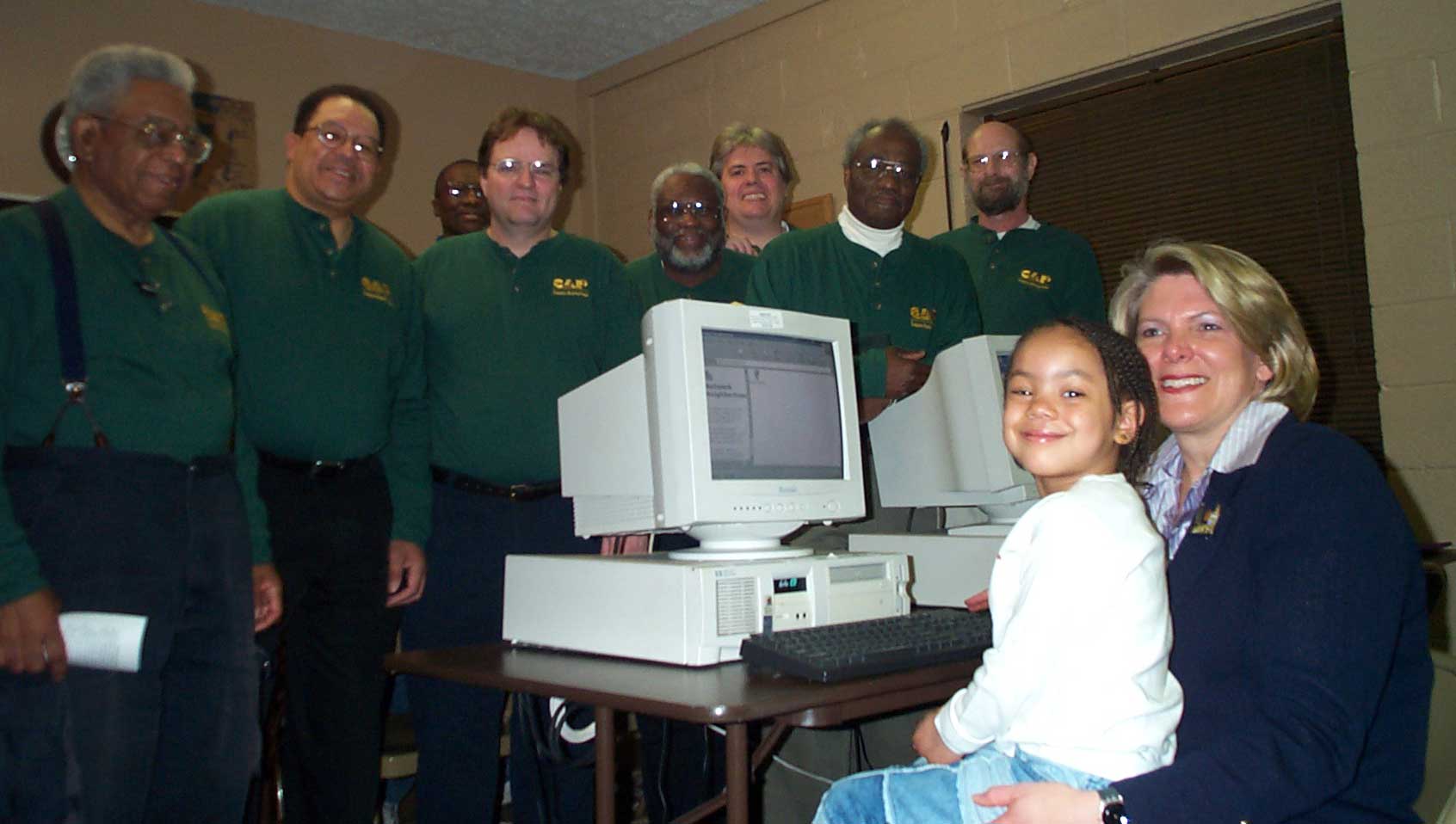 CAP volunteers Dan Davenport, George Long, Henry Burney, Dan McMillan, Arthur Phelps, Dan Hanson, Ken Eskridge, Tom Pechnick <br>with Mayor Campbell and her young computer tutor in the new computer lab